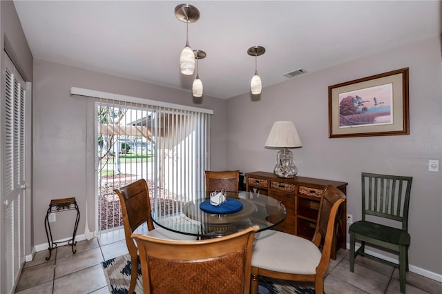 dining space featuring light tile patterned flooring