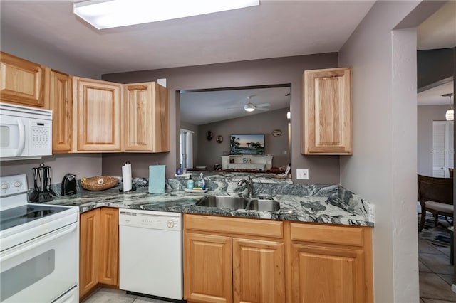 kitchen featuring lofted ceiling, sink, light tile patterned floors, white appliances, and ceiling fan