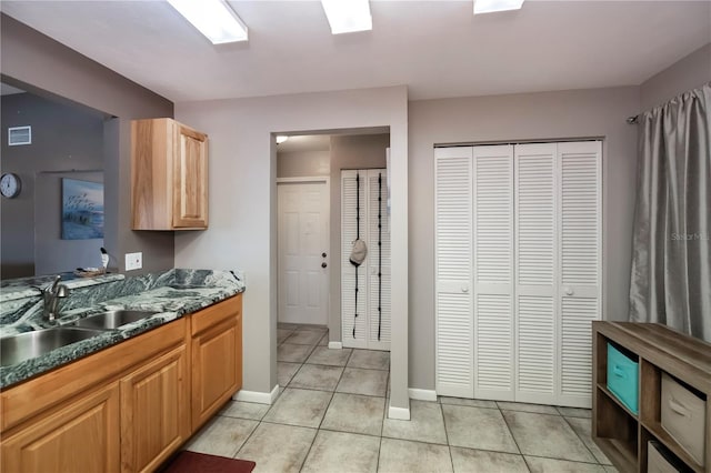 kitchen featuring sink and light tile patterned floors