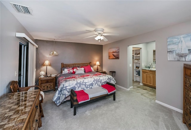 carpeted bedroom featuring connected bathroom and ceiling fan