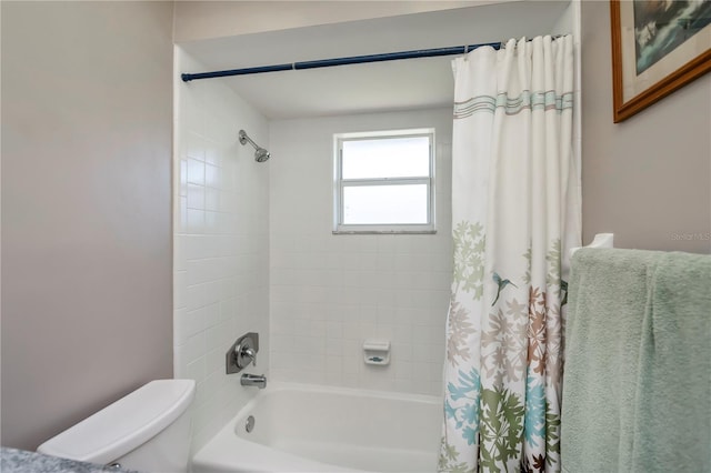 bathroom with toilet and shower / bathtub combination with curtain