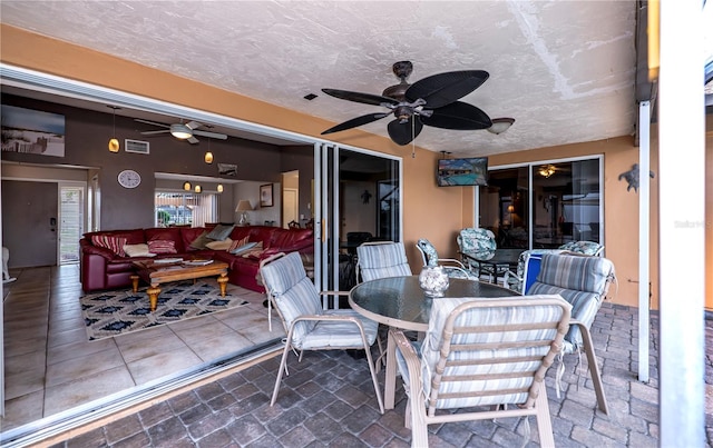 view of patio / terrace featuring ceiling fan