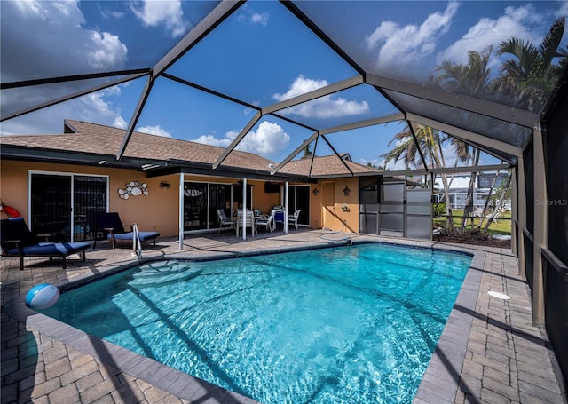 view of pool with a patio and a lanai