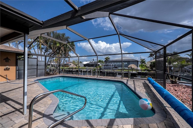 view of swimming pool with a patio and a lanai