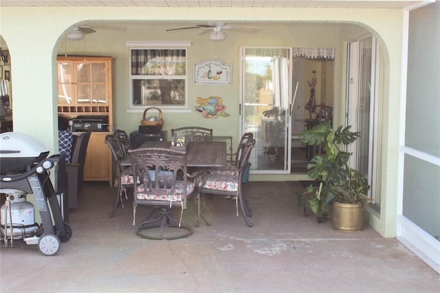 dining space featuring ceiling fan and concrete flooring