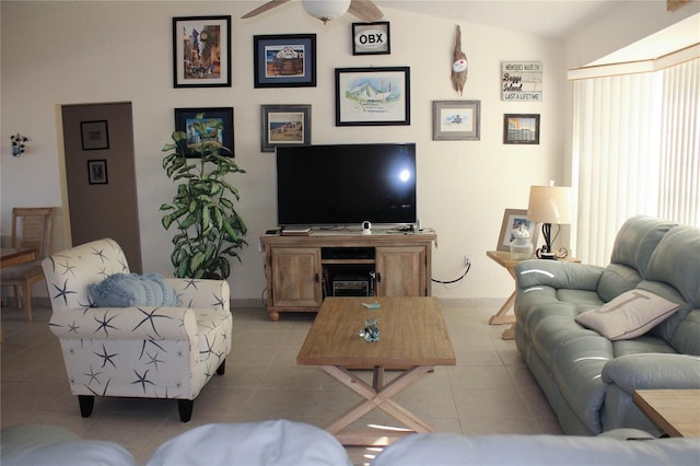 living room with ceiling fan, light tile patterned flooring, and vaulted ceiling