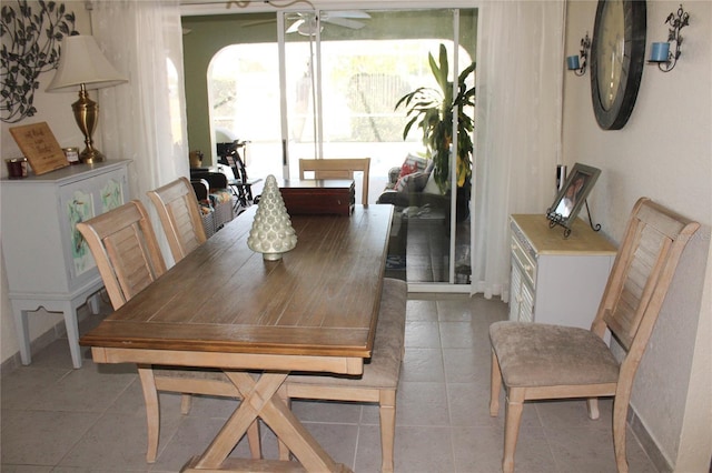 tiled dining area featuring ceiling fan