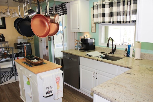 kitchen featuring dishwasher, sink, white cabinetry, and light stone counters