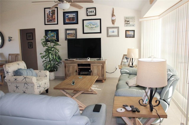 living room with ceiling fan, light tile patterned floors, and lofted ceiling