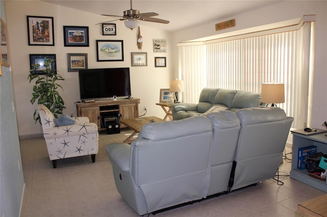 living room featuring ceiling fan, light tile patterned floors, and lofted ceiling