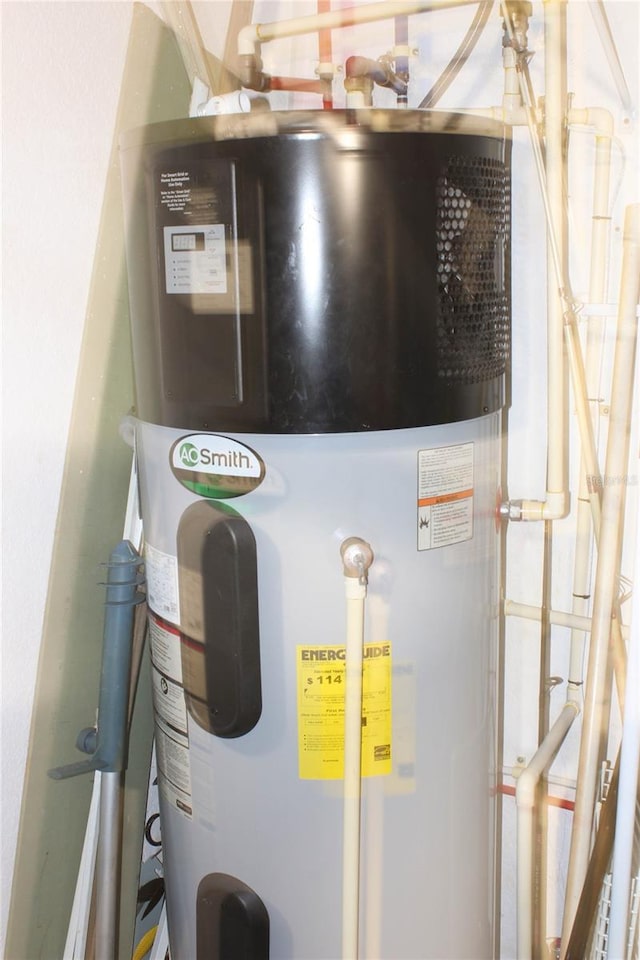 utility room featuring heat pump water heater