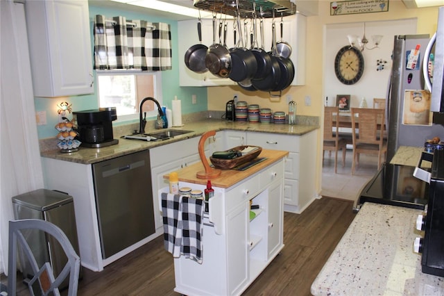 kitchen featuring kitchen peninsula, appliances with stainless steel finishes, dark hardwood / wood-style flooring, sink, and white cabinetry