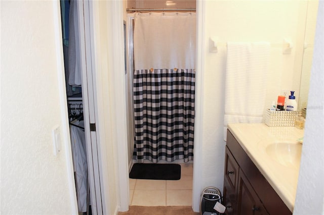 bathroom with curtained shower, tile patterned flooring, and vanity