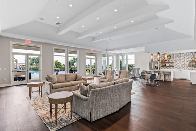 living room featuring a tray ceiling, dark wood-type flooring, visible vents, and recessed lighting