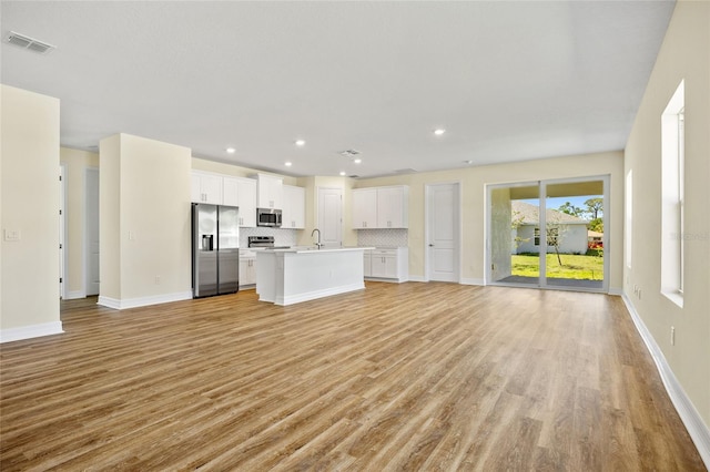 1293 Preston St, Port Charlotte, FL 33952 - unfurnished living room with light wood-type flooring and recessed lighting