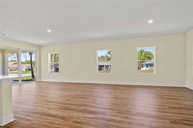 1293 Preston St, Port Charlotte, FL 33952 - unfurnished living room featuring wood finished floors and recessed lighting