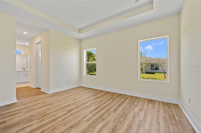 1293 Preston St, Port Charlotte, FL 33952 - empty room with light wood finished floors, recessed lighting, and a tray ceiling