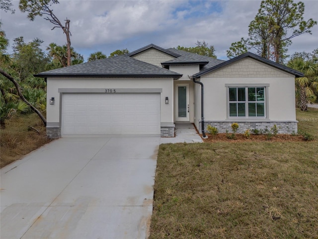 view of front of home featuring a garage and a front lawn