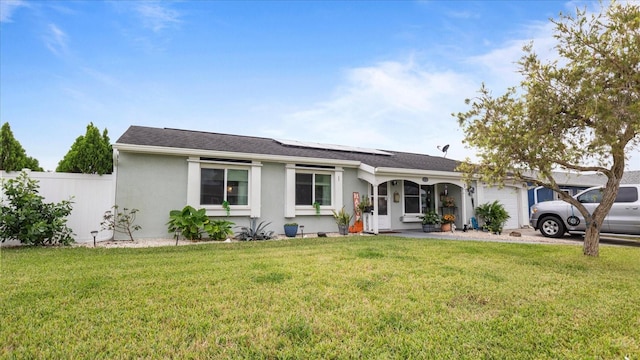 ranch-style home with a garage and a front yard