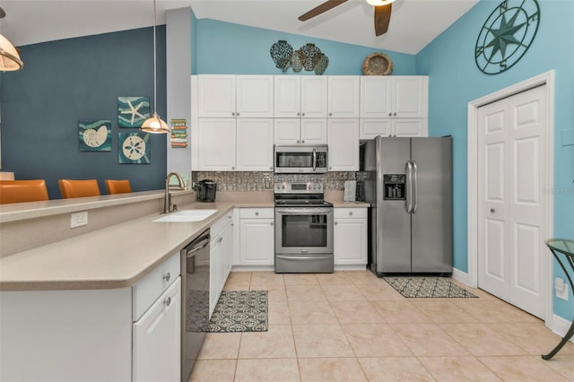 kitchen featuring sink, decorative backsplash, decorative light fixtures, white cabinetry, and stainless steel appliances