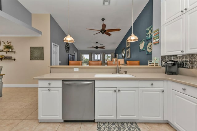 kitchen with kitchen peninsula, vaulted ceiling, sink, dishwasher, and hanging light fixtures