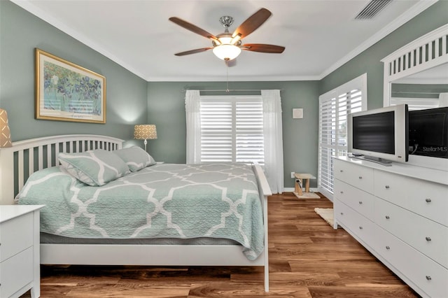 bedroom featuring ceiling fan, ornamental molding, and hardwood / wood-style flooring