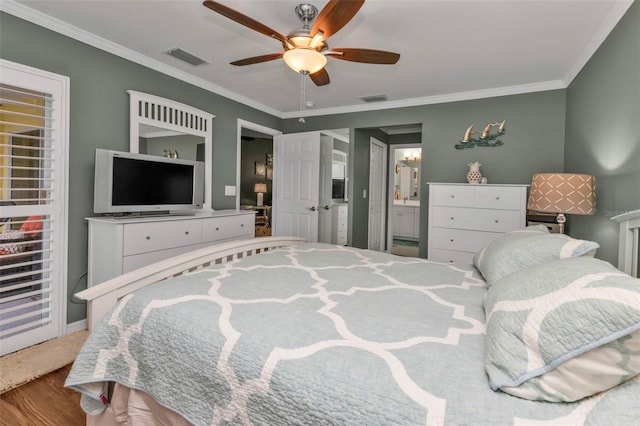 bedroom with hardwood / wood-style floors, connected bathroom, ceiling fan, and ornamental molding