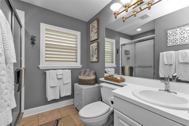 bathroom with tile patterned floors, a chandelier, toilet, vanity, and a shower with shower door