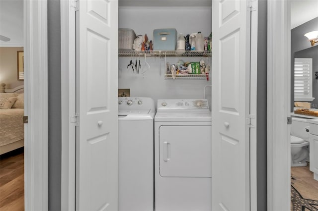 laundry room featuring hardwood / wood-style flooring and independent washer and dryer