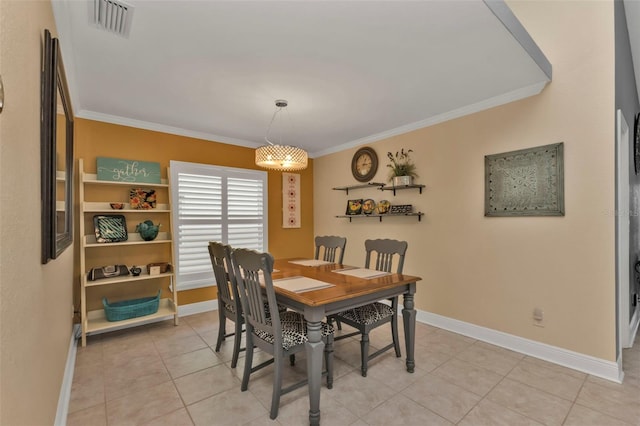 dining space with crown molding and light tile patterned flooring