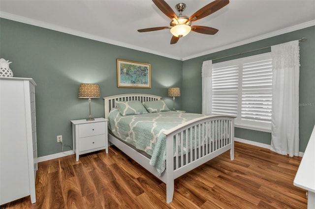 bedroom featuring ceiling fan, dark hardwood / wood-style floors, and ornamental molding