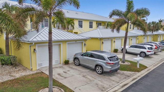2000 Bal Harbor Blvd Unit 321, Punta Gorda, FL 33950 - townhome / multi-family property featuring a standing seam roof, stucco siding, concrete driveway, and metal roof