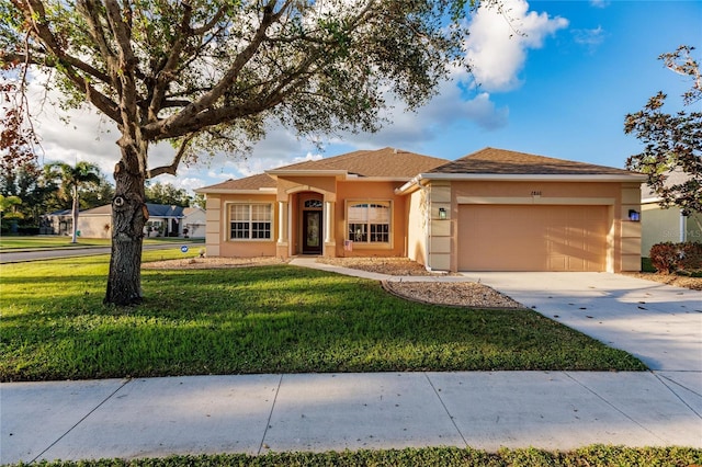 view of front of home with a garage and a front yard