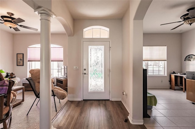 foyer with ceiling fan, wood-type flooring, and ornate columns