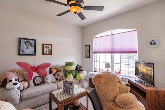 carpeted living room with ceiling fan