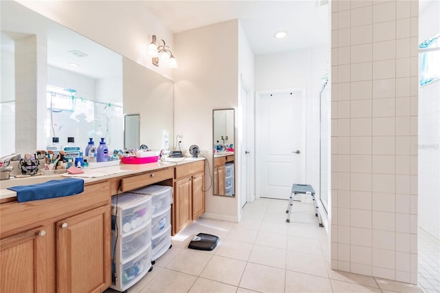 bathroom featuring walk in shower, vanity, and tile patterned floors