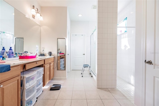 bathroom featuring a shower, vanity, and tile patterned flooring