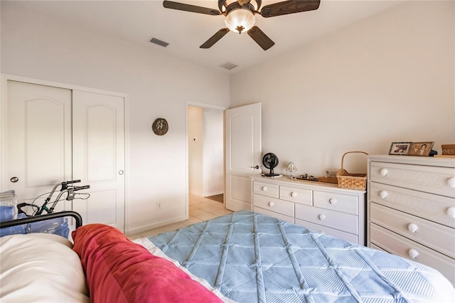 bedroom featuring light tile patterned flooring, ceiling fan, and a closet