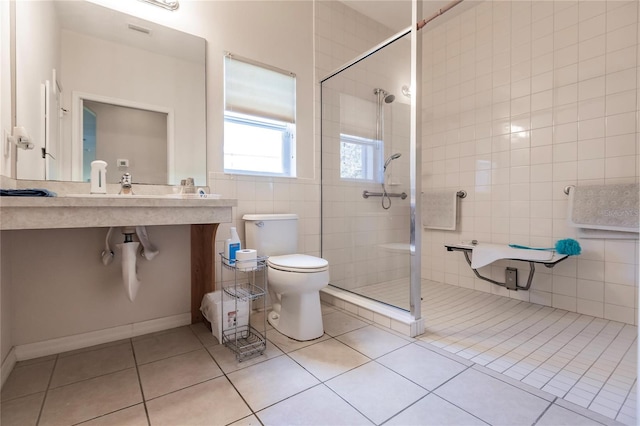 bathroom featuring walk in shower, toilet, and tile patterned flooring