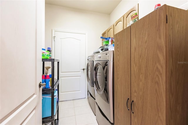 laundry room featuring light tile patterned floors and washer and clothes dryer