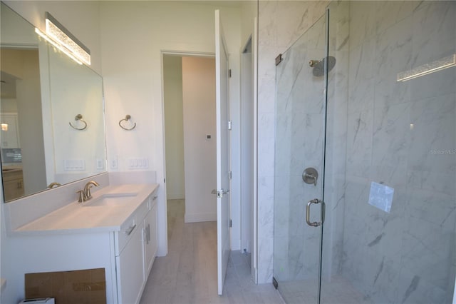 bathroom with vanity, hardwood / wood-style flooring, and a shower with shower door