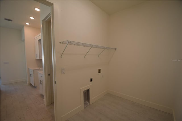 laundry area with hookup for an electric dryer, light hardwood / wood-style flooring, and washer hookup