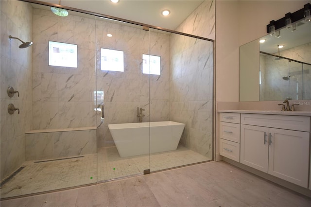 bathroom featuring vanity, independent shower and bath, wood-type flooring, and tile walls