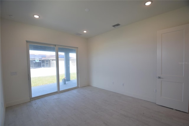 spare room with light hardwood / wood-style floors