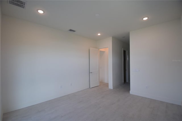 unfurnished room with light wood-type flooring