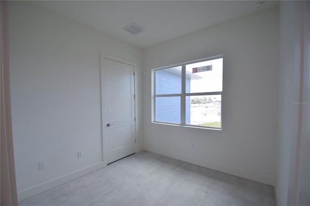 spare room featuring light hardwood / wood-style flooring