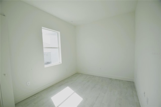 unfurnished room with light wood-type flooring