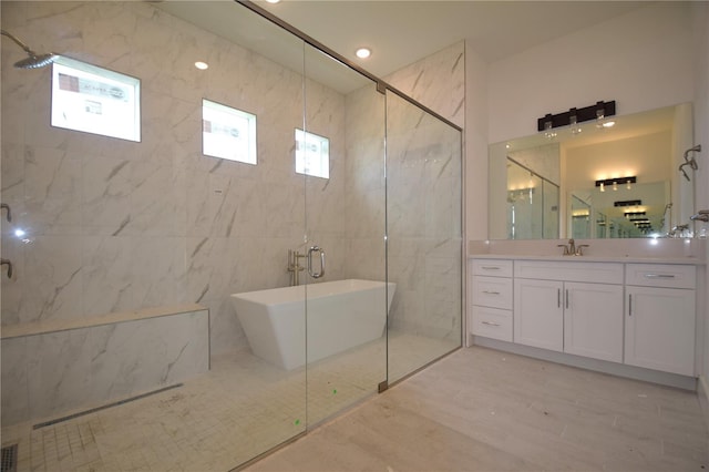 bathroom featuring vanity, tile walls, and plus walk in shower