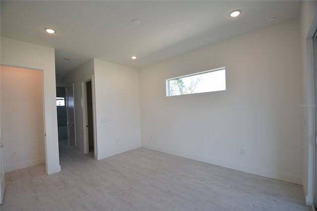 empty room with light hardwood / wood-style flooring