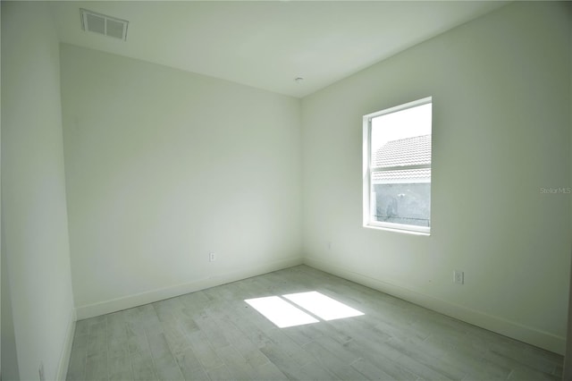 empty room with light hardwood / wood-style flooring